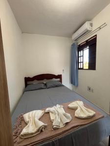 a bedroom with a bed with two towels on it at Apartamento na Praia do Francês AL in Praia do Frances