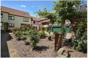 a house with a garden in front of it at Gerstels Ferienhof in Hörselberg-Hainich