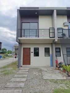 a house with a balcony on the side of it at Goshen Haus in Baclayon