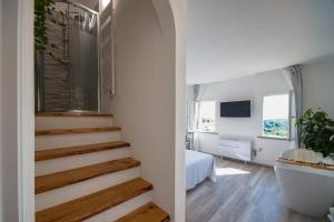 a bathroom with a stairway leading to a bedroom at B&B da Baba in Ghizzano