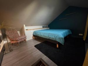 a small bedroom with a bed and a chair at Les lauriers du loft in Pazayac +9 photos