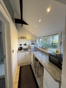 a kitchen with a long counter in a room at Crossways Beech Tree in Grimsby