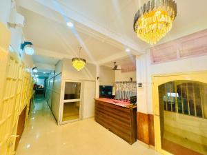 a room with two chandeliers and a counter in it at Mannat Lodge in Hailākāndi