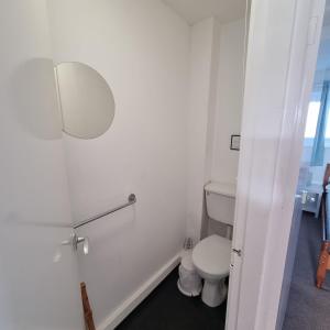 a white bathroom with a toilet and a sink at Penrhyn Cottage Tyn Don in Llanengan