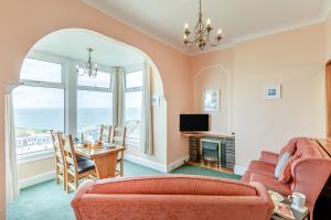 a living room with a couch and a table at Ocean View in Ilfracombe