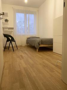 a bedroom with a bed and a desk and a window at Berlin in Niederdorla