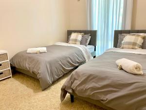 two beds sitting next to each other in a bedroom at Luxe Ranch in Swan Hill