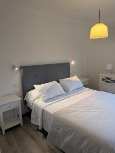 a bedroom with a large white bed with two pillows at Lavilla1XO in Valverde