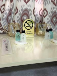 a table with three bottles and glasses on it at Mansarda hostel in Samarkand