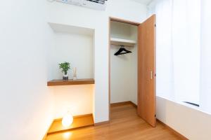 a hallway with a door leading into a room at NTK House Yokohama in Yokohama