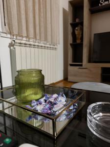 a glass table with a green vase on top of it at Barbello in Stara Pazova +12 photos