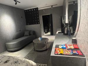 a living room with a couch and a table at استديو المنام الراقي in Medina
