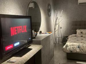 a living room with a flat screen tv on a counter at استديو المنام الراقي in Medina