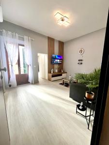 a living room with a couch and a tv at Empoli Charm in Empoli
