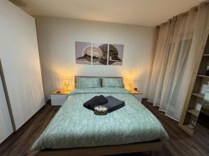 a bedroom with a green bed with two night stands at Satori House in Sanremo +19 photos