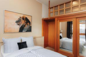 a bedroom with a bed and a lion picture on the wall at Seabreeze Suite in Füssen
