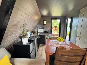 a kitchen with a table and a counter top at Inato Suites- Teepee House in Panglao Island