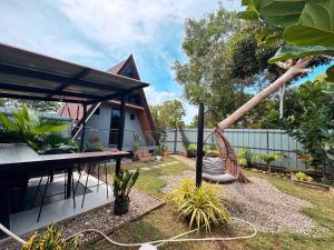 a patio with a hammock in a yard at Inato Suites- Teepee House in Panglao Island