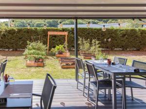a table and chairs sitting on a deck at ibis Lyon Est Chaponnay in Chaponnay