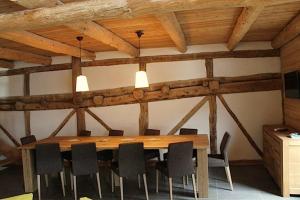 a conference room with a wooden table and chairs at 10214 Chalet d'exception nature sport et bien être sauna,jacuzzi hammam frigidarium in Cervières