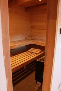 a small wooden sauna with a bench in it at 10214 Chalet d'exception nature sport et bien être sauna,jacuzzi hammam frigidarium in Cervières