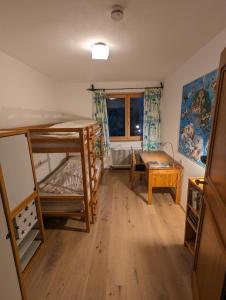 a room with two bunk beds and a table at Ferienhaus Lengau in Saalbach-Hinterglemm
