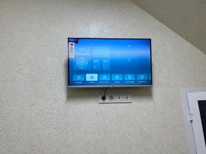 a flat screen tv hanging on a wall at Mansarda hostel in Samarkand +24 photos