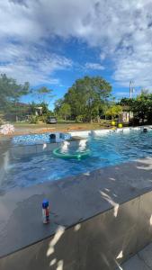 a small boat in the water in a swimming pool at Inato Suites- Teepee House in Panglao Island