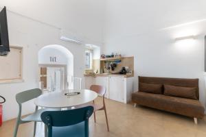 a living room with a table and a couch at Suite Diffuse - Widespread Suite Collection PCB LUXURY in Ostuni