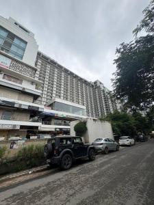 a jeep parked in front of a large building at The Pineapple Suite with Gorgeous Views in Greater Noida