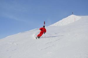 a man is skiing down a snow covered slope at Ferienhaus Lengau in Saalbach-Hinterglemm