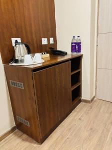 a wooden counter top with a coffee maker on it at The Pineapple Suite with Gorgeous Views in Greater Noida