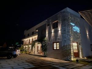a building with lights on the side of it at night at Pousada Na Serra in Ubajara