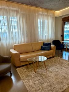 a living room with a couch and a table at smgold lux apartman in Podgorica