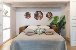 a bedroom with a bed with three pictures on the wall at Suite Diffuse - Widespread Suite Collection PCB LUXURY in Ostuni +70 photos