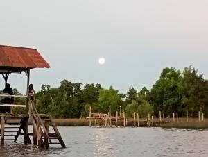 a woman standing on a dock in the water at Casablanca in Tigre