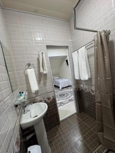 a bathroom with a sink and a shower at Mansarda hostel in Samarkand