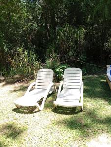 two white lawn chairs sitting next to each other at Casablanca in Tigre