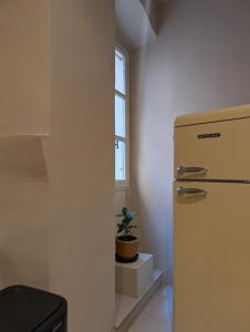 a kitchen with a refrigerator and a potted plant at Provencal Escape - Suite in Saint Paul de Vence +16 photos