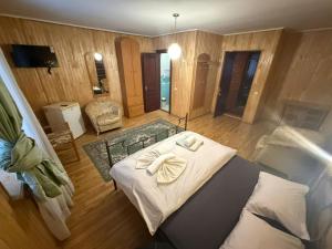 a bedroom with a bed with a towel on it at Hotel palas tatariv in Tatariv