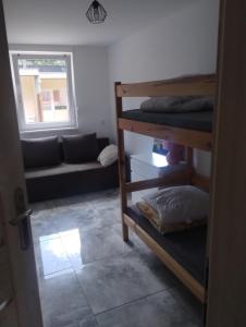 a room with two bunk beds and a couch at U Irka in Skorzęcin