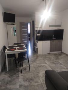 a kitchen with a table and chairs in a room at U Irka in Skorzęcin