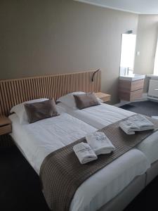 a bedroom with a bed with two towels on it at 't Streefkerkse Huis in Zoutelande +55 photos