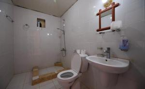 a white bathroom with a toilet and a sink at Milky Way Bedouin Camp in Wadi Rum +60 photos