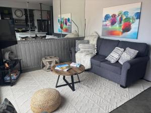 a living room with a couch and a coffee table at Exclusive Modern Suite view in Kamloops