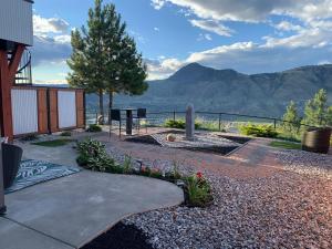 a garden with a view of the mountains at Exclusive Modern Suite view in Kamloops