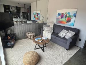 a living room with a couch and a table at Exclusive Modern Suite view in Kamloops +33 photos