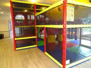 a play room with a play gym with a slide at Mobilehome Super Mercure 2 Bedrooms Comfort Camping Scheldeoord in Baarland +21 photos