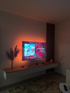 a living room with a flat screen tv on a wall at Modern Air Conditioned 2BR in Heart of Shkodër in Shkodër