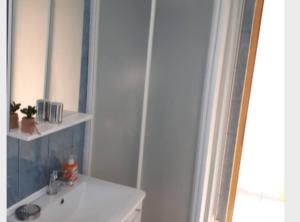 a bathroom with a sink and a mirror at Apartment Dijana in Bakar